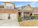Inviting brick home with a two-car garage and a beautifully landscaped front yard at 498 Townsend St, Grayson, GA 30017