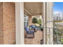 Cozy front porch with brick flooring, comfortable seating, and decorative plants at 498 Townsend St, Grayson, GA 30017