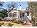Quaint bungalow with charming front porch, painted white brick, and an inviting entryway at 1290 Oxford Ne Rd, Atlanta, GA 30306