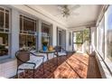 Cozy screened front porch featuring tiled flooring, ceiling fan, and outdoor seating at 1290 Oxford Ne Rd, Atlanta, GA 30306