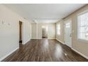 Spacious living room with new wood flooring, fresh paint, and a view into the kitchen at 1542 Columbia Dr, Decatur, GA 30032