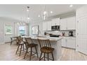 Bright kitchen with white cabinets, granite countertops, and stainless steel appliances at 1625 Tide Mill Rd, Cumming, GA 30040
