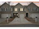 Beautiful townhome with one car garage, complemented by well-maintained landscaping at 2785 Maple Park Pl, Cumming, GA 30041
