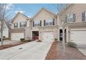 Charming townhome featuring a one car garage and inviting brick and siding exterior at 2785 Maple Park Pl, Cumming, GA 30041