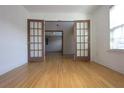Open room with wood floors, french doors, and natural light from a nearby window at 838 Roxholly Ln, Buford, GA 30518