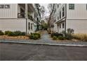 A beautifully landscaped view between modern townhomes with gray gravel and walkway at 4454 Dandelion Ln, Atlanta, GA 30342