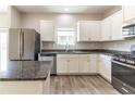 Stylish kitchen featuring white cabinets, granite countertops, and stainless steel appliances at 6399 Woodwell Dr, Union City, GA 30291