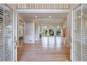 Spacious living room with hardwood floors, large windows, fireplace, and an open entryway to another room at 1140 Matheson Way, Alpharetta, GA 30022