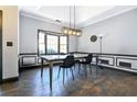 Formal dining room featuring gray walls, dark trim, a bay window, and an elegant chandelier at 3065 Kings Nw Dr, Kennesaw, GA 30144