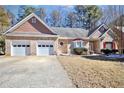 Charming single-story brick home featuring a two-car garage and well-manicured front yard at 3065 Kings Nw Dr, Kennesaw, GA 30144