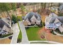 Gorgeous home with manicured lawn, mature trees, and a private driveway, surrounded by lush landscaping at 2601 Floral Valley Dr, Dacula, GA 30019