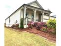 Lovely home exterior showing covered porch, rocking chairs, colorful landscaping, and well kept lawn at 1061 Towne Mill Xing, Canton, GA 30114