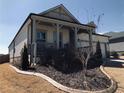 Inviting home showcasing a landscaped yard with decorative brick edging and a covered porch at 1061 Towne Mill Xing, Canton, GA 30114