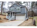 A two-story home featuring a driveway, garage, and charming front porch at 113 Miller Rd, Stockbridge, GA 30281