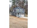 Two-story home featuring a driveway, garage, and covered front porch at 113 Miller Rd, Stockbridge, GA 30281
