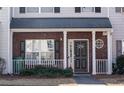 Charming townhouse with a brick facade, covered entry, and black front door at 2744 Snapfinger Mnr, Decatur, GA 30035