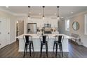 Modern kitchen with sleek appliances, large island with bar seating, and pendant lighting at 4531 Moray Dr, Mableton, GA 30126