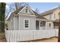 Side view of a gray house with white picket fence and covered porch, exuding charm at 789 Cooper Sw St, Atlanta, GA 30315