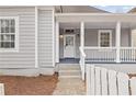 Inviting front porch of a gray home, featuring white railings and detailed trim at 789 Cooper Sw St, Atlanta, GA 30315