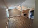 Spacious living room with vaulted ceiling, hardwood floors, and a brick fireplace at 440 Ward Rd, Ellenwood, GA 30294