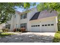 Side view of this lovely two-story house featuring a two-car garage and well-maintained landscaping at 4832 Hidden Creek Pl, Decatur, GA 30035