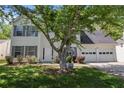 Beautiful two-story house showcasing gray shutters, a white front door, well-manicured landscaping, and an attached garage at 4832 Hidden Creek Pl, Decatur, GA 30035