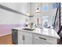 Bright kitchen island features stainless steel appliances, quartz countertops, and a copper faucet for an elevated look at 260 18Th Nw St # 10202, Atlanta, GA 30363
