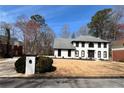 Beautiful two-story home with white exterior, dark trim, a spacious front yard, and adjacent mailbox at 4960 Trevino Cir, Duluth, GA 30096
