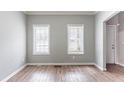 Open living space with two windows and wood flooring, offering natural light and a modern feel at 202 Nathan Sw Rd, Atlanta, GA 30331