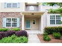 Inviting home entrance with covered porch and neatly arranged landscape at 2453 Suwanee Pointe Dr, Lawrenceville, GA 30043