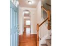 Welcoming home foyer featuring hardwood floors and a staircase to the upper level at 2453 Suwanee Pointe Dr, Lawrenceville, GA 30043