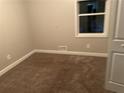 Cozy bedroom with neutral paint, and a window allowing natural light at 8229 Queens Dr, Jonesboro, GA 30238