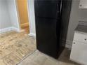 Kitchen area featuring a black refrigerator with updated cabinetry and floors at 8229 Queens Dr, Jonesboro, GA 30238