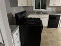 Well-equipped kitchen featuring a stove and dishwasher, and ample counter space at 8229 Queens Dr, Jonesboro, GA 30238