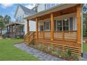 Inviting front porch with wooden columns and a cozy seating area at 830 Gaston Street Sw, Atlanta, GA 30310