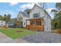 Beautiful new home with a charming wood porch in a suburban neighborhood at 830 Gaston Street Sw, Atlanta, GA 30310