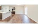 Open concept floor plan combining the kitchen and dining area with hardwood flooring at 811 Lake Chase, Fairburn, GA 30213