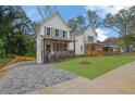 View of the charming two-story home with a landscaped yard and a paved driveway at 826 Gaston Street Sw, Atlanta, GA 30310