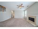 Inviting living room featuring a fireplace, neutral walls, and staircase access at 104 Shadow Creek Ct, Fairburn, GA 30213
