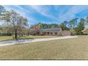 Ranch-style home featuring a two-car garage, a long driveway, and a well manicured lawn at 110 Eastfield Ct, Mcdonough, GA 30252