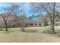 Inviting single-story home with mature trees providing shade and curb appeal at 110 Eastfield Ct, Mcdonough, GA 30252