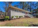 This exterior shot shows the brick facade and covered front entry of this charming ranch at 1584 Belva Ave, Decatur, GA 30032