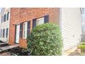 A view of the side of a home with brick and siding and manicured landscaping at 5582 Windwood Rd, Atlanta, GA 30349