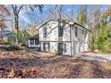 Side view of the house showing the driveway and garage and surrounding foliage at 5916 Simone Dr, Stone Mountain, GA 30087