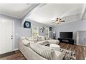 Bright living room featuring a plush sectional sofa, modern decor, and ample natural light from large windows at 5916 Simone Dr, Stone Mountain, GA 30087