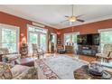 Bright living room featuring hardwood floors, large windows, a ceiling fan and stylish furnishings at 1000 Nw Main St, Conyers, GA 30012