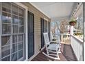 Inviting covered porch with rocking chairs, perfect for relaxing outdoors at 127 Hyde Way, Dallas, GA 30157