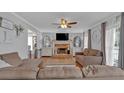 Cozy living room featuring a fireplace and abundant natural light at 127 Hyde Way, Dallas, GA 30157