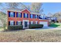 Charming two-story brick home with manicured landscaping and an attached two-car garage at 2697 Links Overlook Drive Dr, Dacula, GA 30019