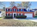 Charming two-story brick home with manicured landscaping and an attached two-car garage at 2697 Links Overlook Drive Dr, Dacula, GA 30019
